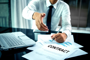 Business offering a handshake and contract