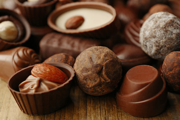 Assortment of delicious chocolate candies background, close up
