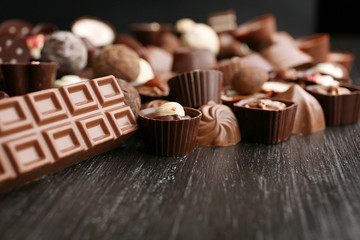 Delicious chocolate candies on wooden background