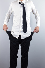 Businessman shows empty pockets