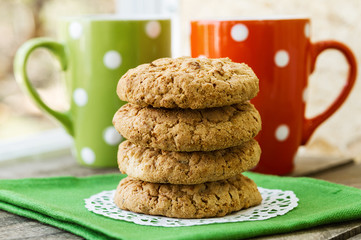 homemade cookies on the table, colored tea cups