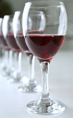 Glasses of red wine on white table closeup