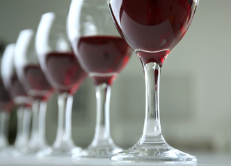 Glasses of red wine on white table closeup