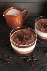 Delicious dessert with chocolate powder and coffee beans in glass