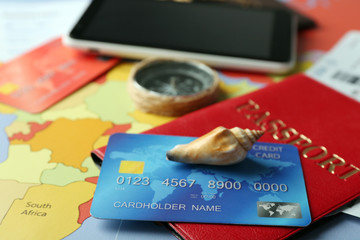 Credit cards with passports and tickets for vacations on the world map background