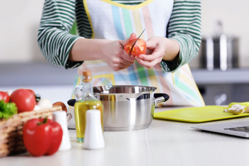 Young woman cooking in the kitchen