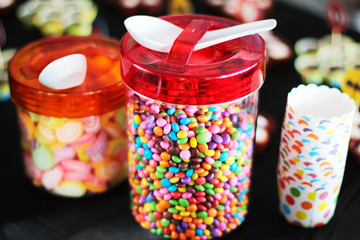 Fototapeta na wymiar Various sugary candy in a glass jar