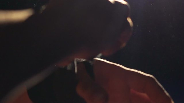 Close up boxer wrapping bandages on his hand before fight. Slow motion