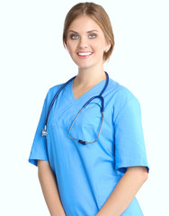 Portrait of young woman doctor with blue coat standing in hospital