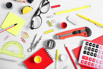 Set of stationery on white table, top view