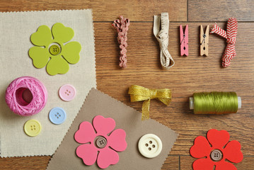 Sewing creative accessories on wooden table, top view