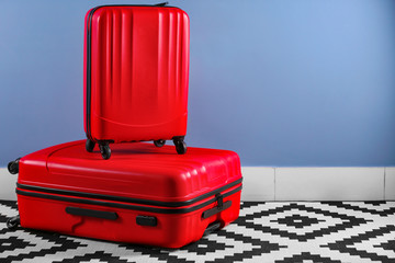 Suitcases on blue wall background