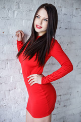 Young woman in a sexy short red dress