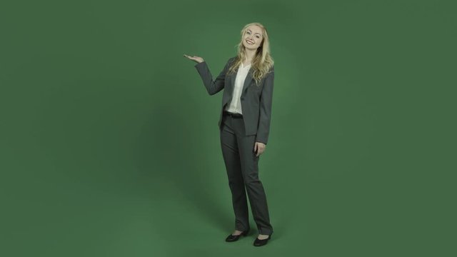 caucasian businesswoman isolated on chroma green screen background pointing presenting