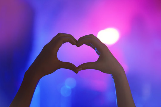 Heart shaped hands on a concert.