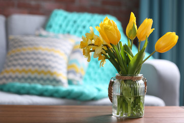 Yellow spring flowers in living room interior
