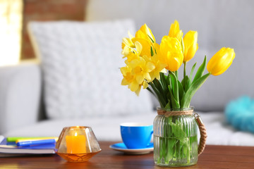 Yellow spring flowers in living room interior