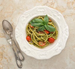 pasta spaghetti with cherry tomatoes and basilikum in a plate