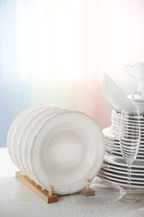 Set of new white dishes on wooden table, indoors