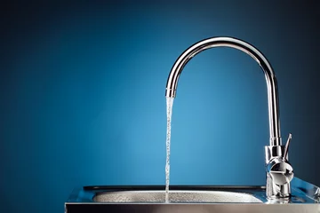Fototapete Wasser Mischbatterie mit fließendem Wasser, blauer Hintergrund