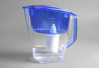 Water filter jug on the grey background