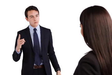 Young Caucasian business man reprimanding business woman
