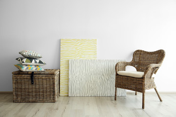 Wicker furniture on light wall background