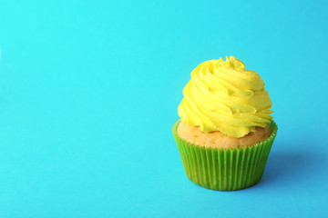 Birthday cupcake on turquoise background