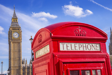 Fototapeta na wymiar The Big Ben with famous British red telephone box on a sunny day with blue sky - London, UK