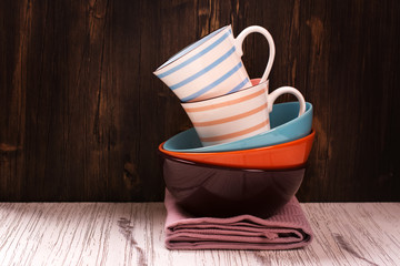 Kitchen cooking utensils with napkins over wooden table