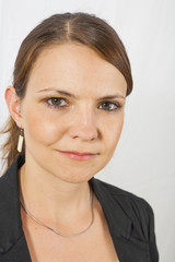 portrait of a beautiful young woman on light background