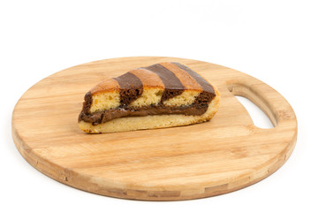 Triangular chocolate cake on the wooden kitchen board