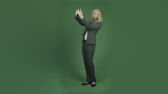 caucasian businesswoman isolated on chroma green screen background selfie