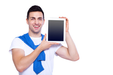 Copy space on his tablet. Happy young man showing his digital tablet and smile while standing isolated on white background