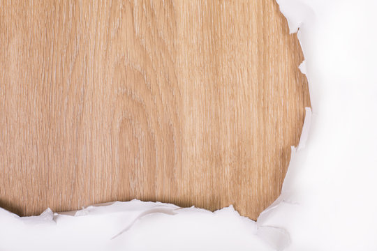 Torn paper wooden surface closeup