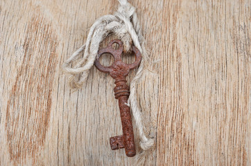 Vintage key on wooden background