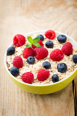 Oatmeal porridge with berries. Raspberries and blueberries.