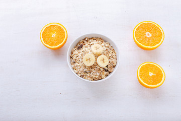 Granola, bananas and orange slices