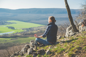 Woman practice yoga on top of the hill