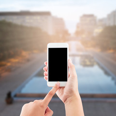 Female hand using mobile smartphone blurred background - mockup