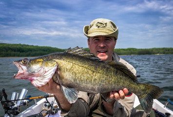 Obraz premium Happy angler with huge walleye