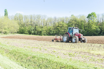 Fototapeta premium Tractor plowing the fields