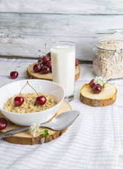 Healthy breakfast with cherry, oatmeal and milk