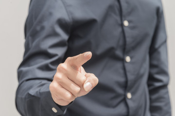 Business man point something with finger isolated on grey background