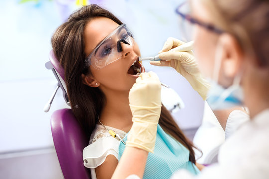 Overview of dental caries prevention.Woman at the dentist's chair during a dental procedure. Beautiful Woman smile close up. Healthy Smile. Beautiful Female Smile

