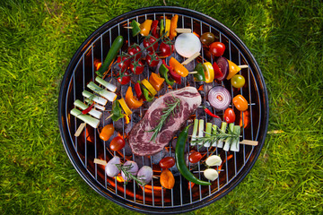 Delicious beef meat with vegetable on a barbecue grill.