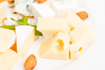 Assorted cheese platter with almonds closeup.