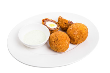Baked scotch eggs with tartar sauce.