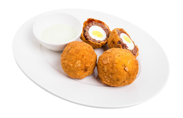 Baked scotch eggs with tartar sauce.