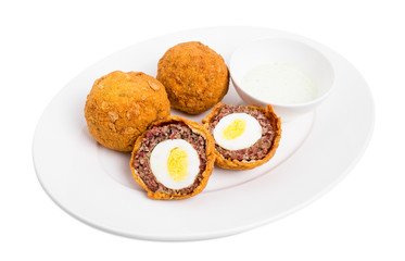 Baked scotch eggs with tartar sauce.